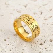 Gold ring with engraved designs on a blue background