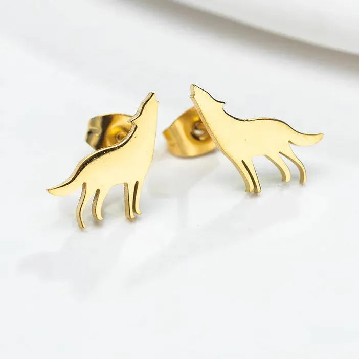 Gold dog-shaped earrings on a white background