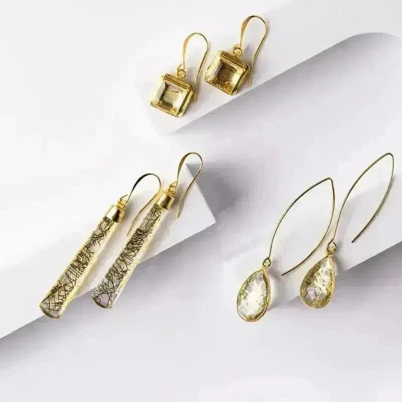 Set of gold earrings on a white background