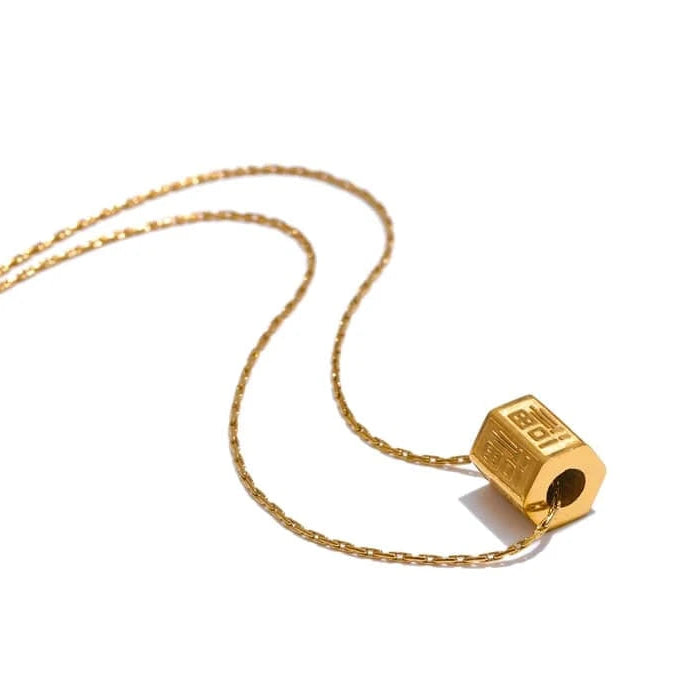 Gold pencil sharpener pendant on a chain against a white background