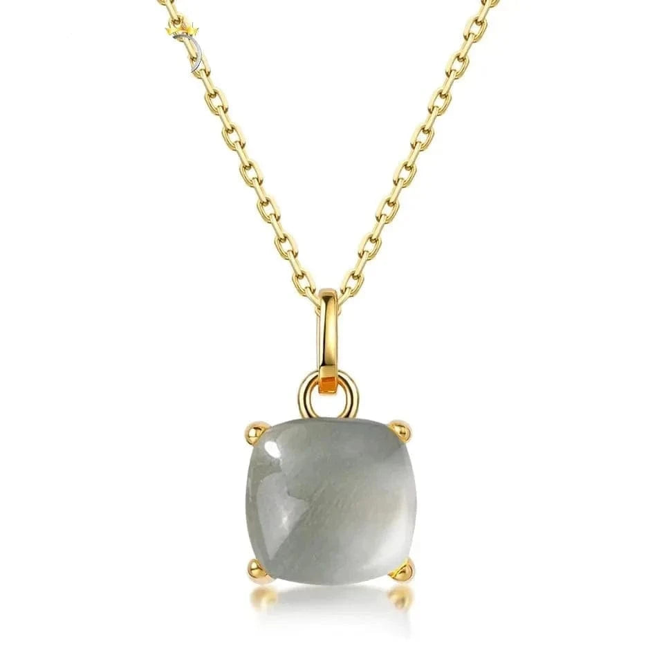 Gold necklace with a gray gemstone pendant on a white background