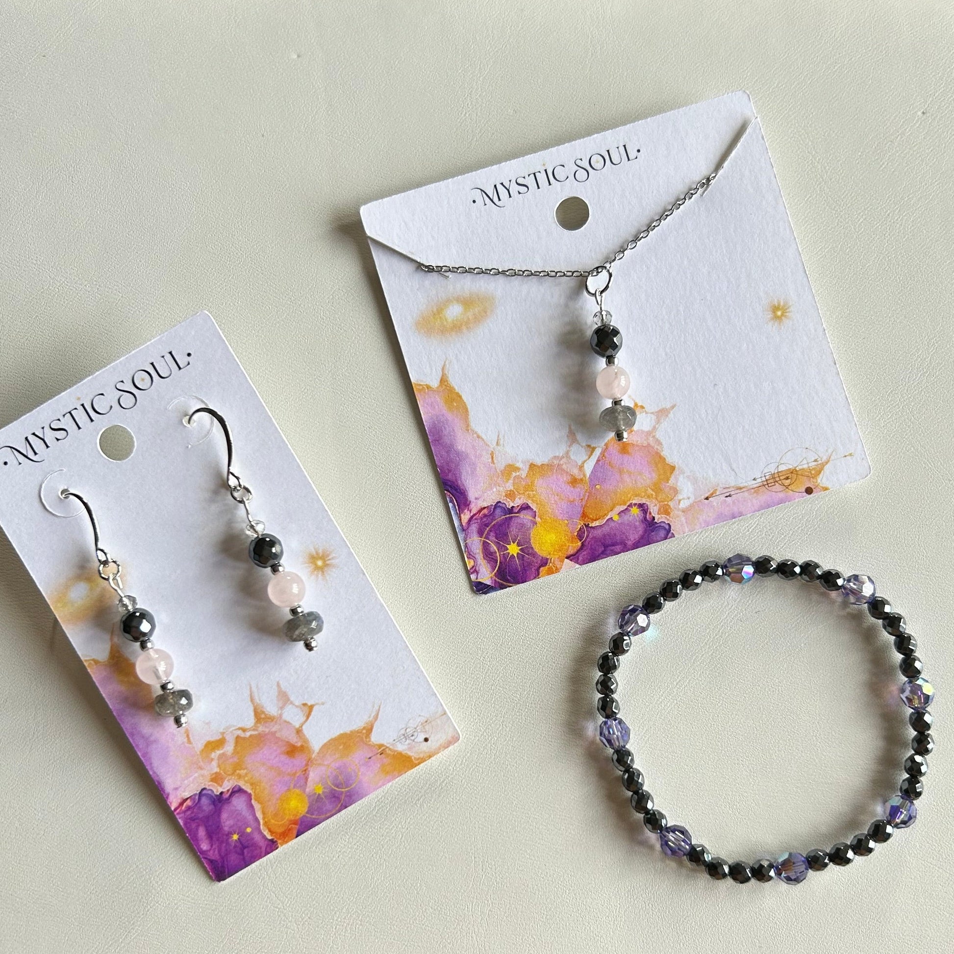 Pyrite, rose quartz and labradorite jewellery grouped together, showing the full Still Light collection from Mystic Soul Jewelry