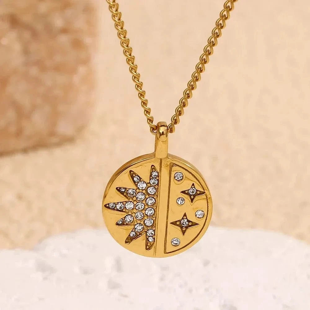 Gold necklace with a circular pendant featuring star designs on a beige background