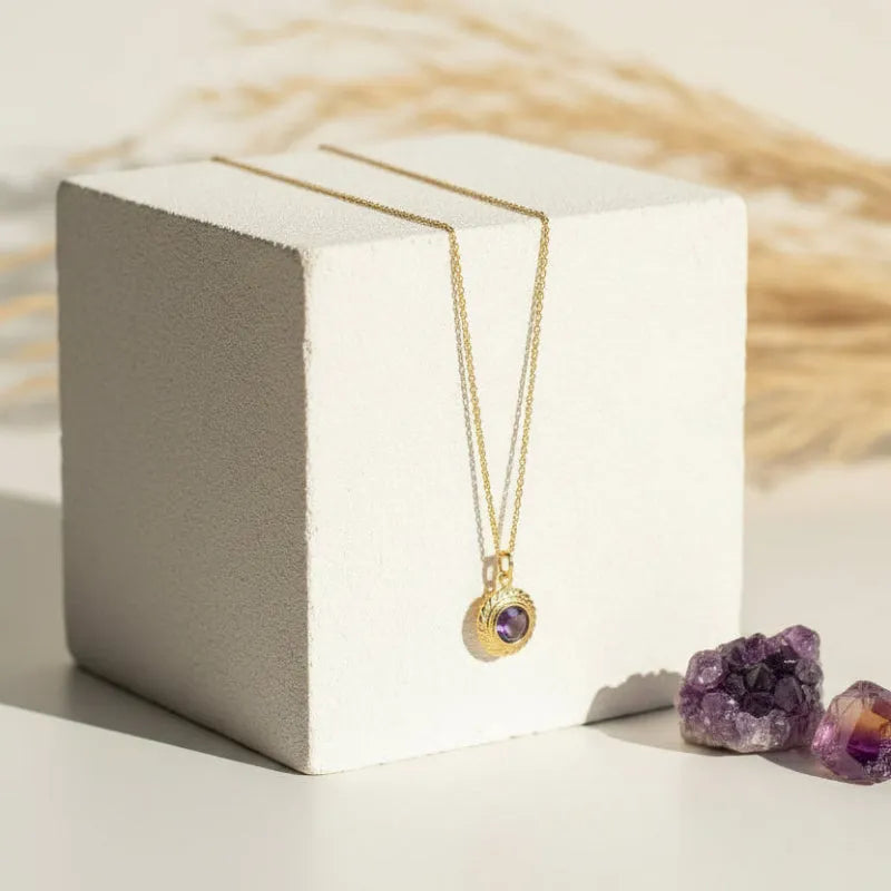 Amethyst Halo pendant necklace hanging on a fine gold chain