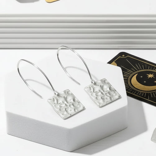 Hammered geometry drop earrings with tarot card design on a white surface, branded as Mystic Soul Jewelry.