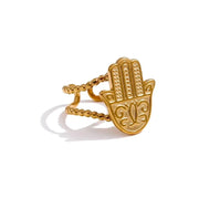 Gold Hamsa hand ring on a white background