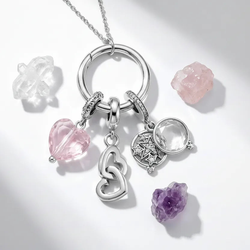 Silver keychain with pink and purple gemstone charms on a light gray background
