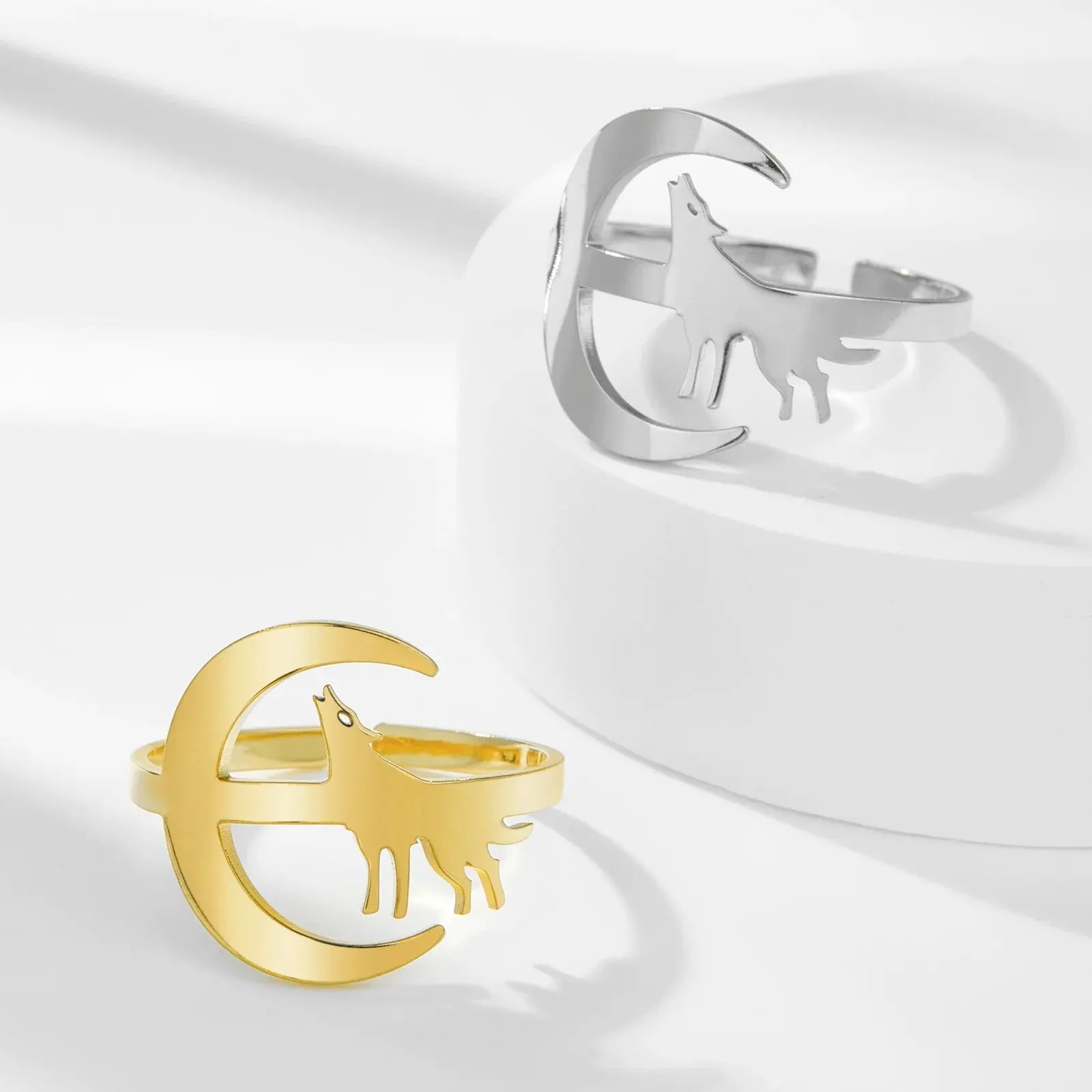 Gold and silver rings with deer and moon design on a white background