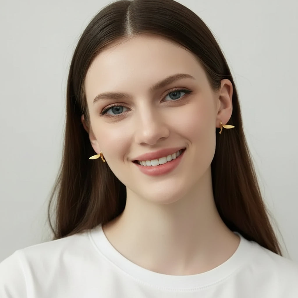 Woman wearing gold hummingbird stud earrings — spirit animal jewelry for joy