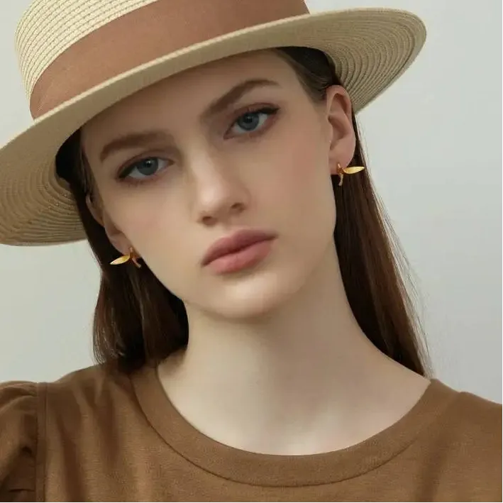 Woman wearing a beige hat and matching top  