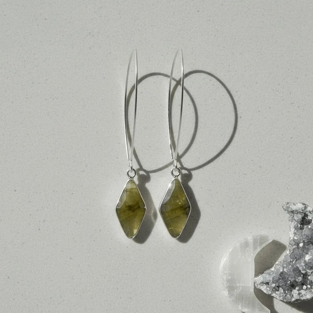 Pair of green stone earrings on a light background