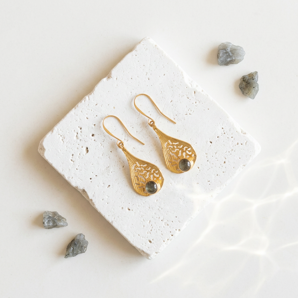 Gold plated filigree teardrop earrings with genuine labradorite on white stone