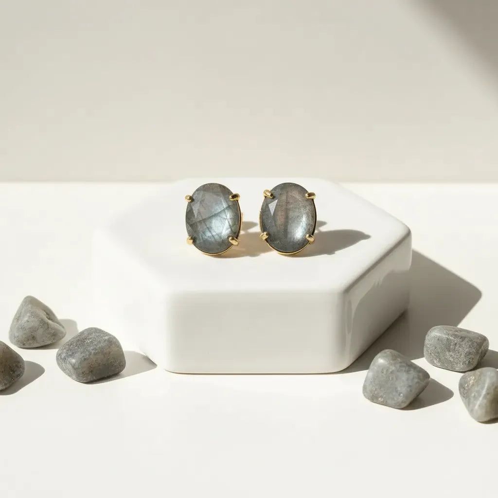 Lapis lazuli earrings on a white surface with lapis stones.