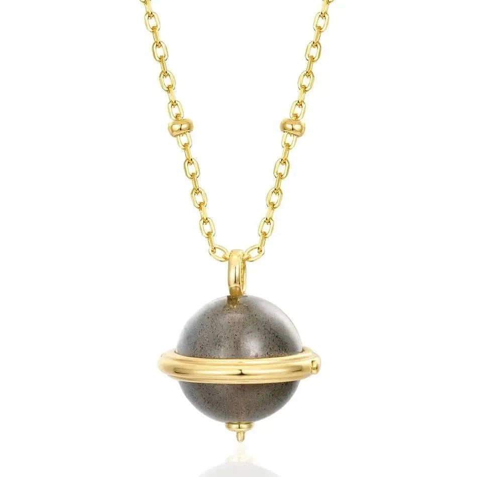 Necklace with a gold chain and gray sphere pendant on a white background