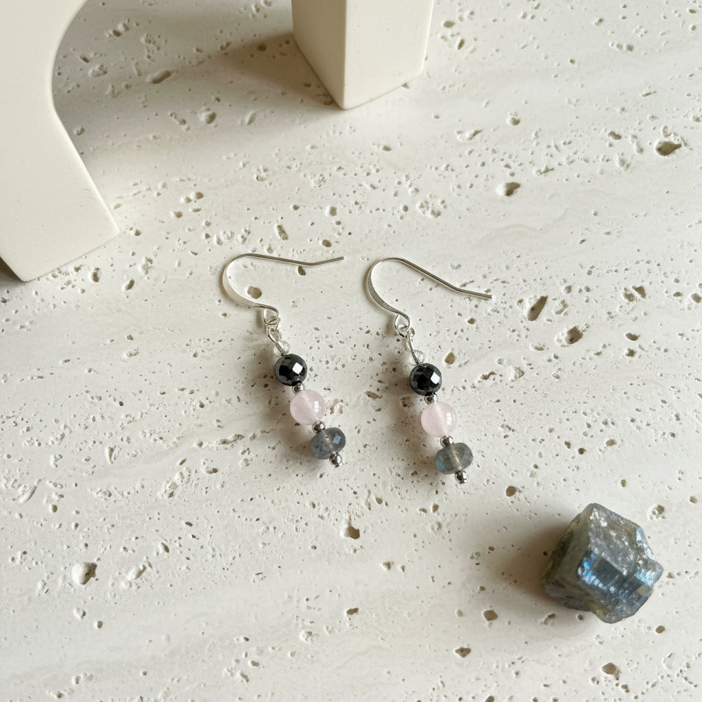 Close view of the labradorite, rose quartz and pyrite drop earrings showing the blue flash in the labradorite