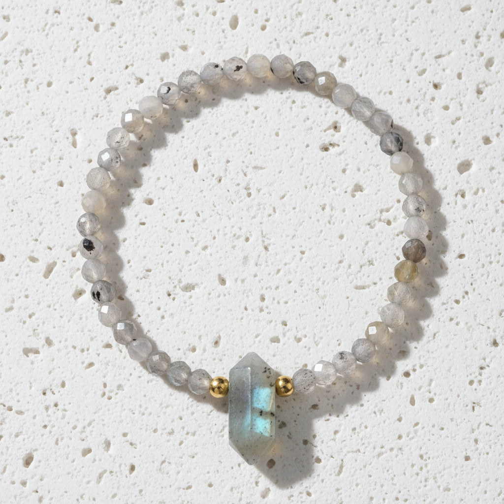 Beaded bracelet with a large stone bead on a white background