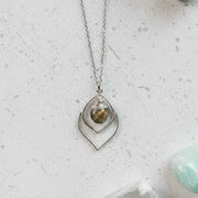 Silver necklace with a pendant on a white background