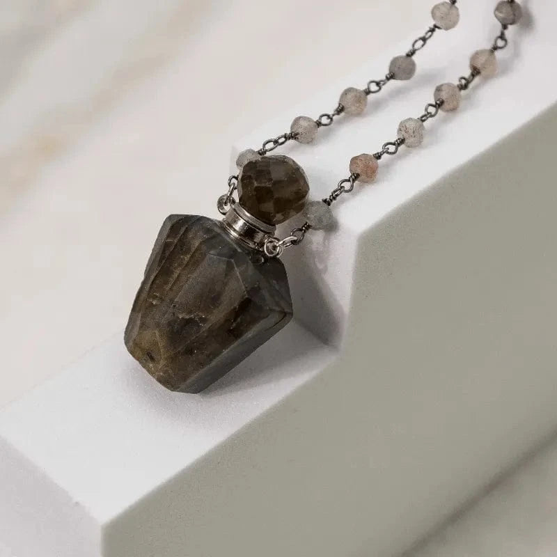 Necklace with a faceted stone pendant on a white surface
