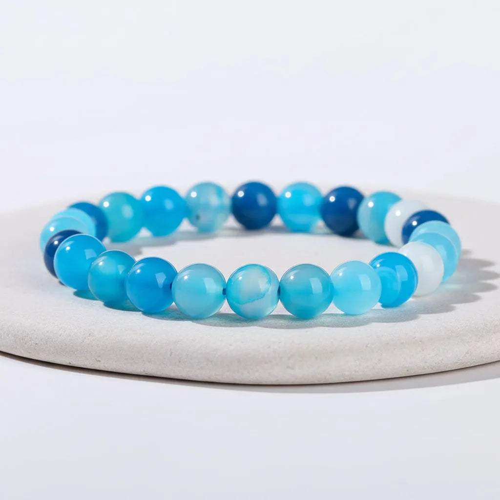 Lake Blue Lace Strip Agate bracelet on a light gray background