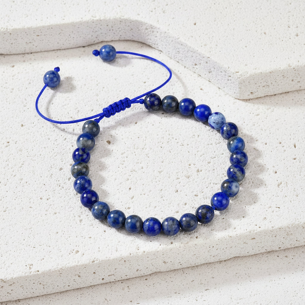 Blue beaded bracelet on a card with text on a wooden surface