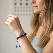 Woman wearing a lapis lazuli bracelet — throat and third eye chakra jewelry for truth