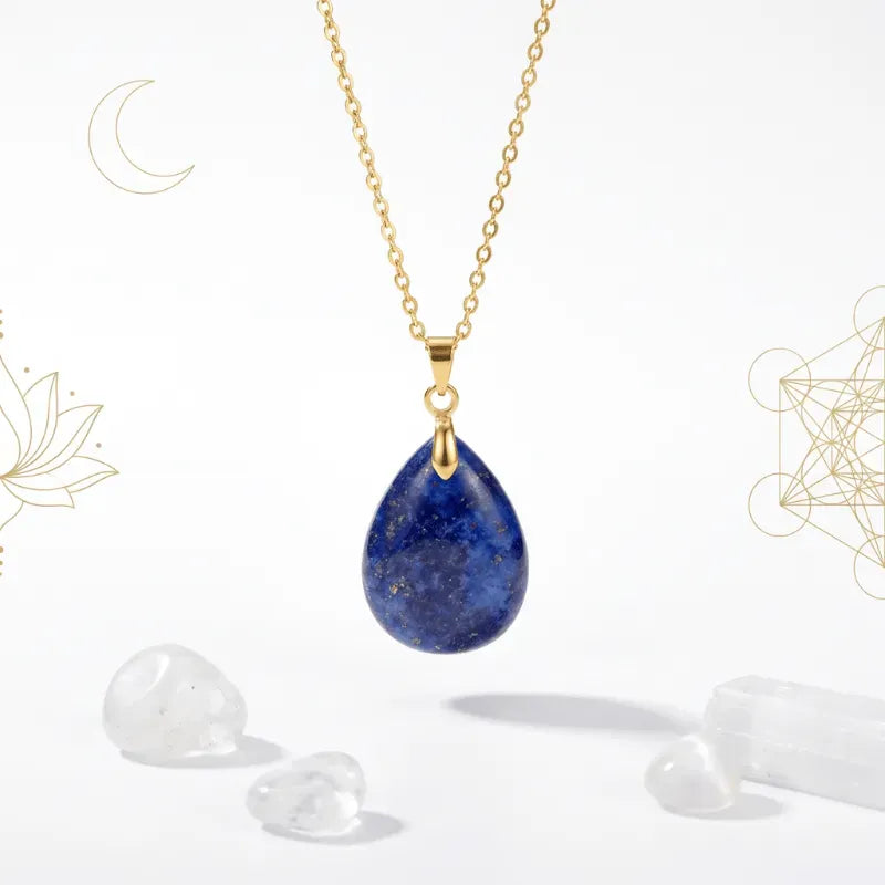 Gold necklace with a blue teardrop pendant on a white background