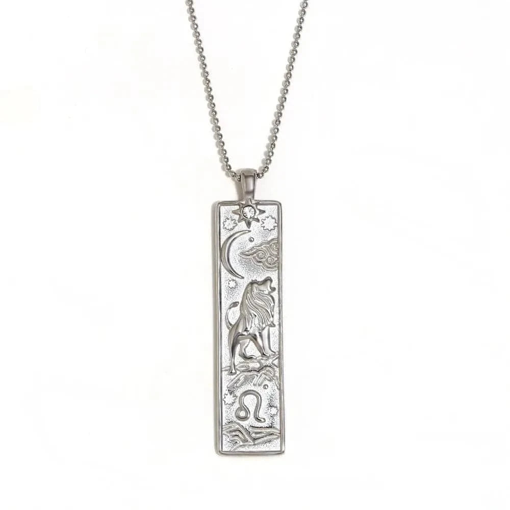 Silver pendant necklace with engraved design on a white background