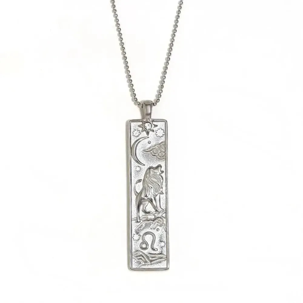 Silver pendant necklace with engraved design on a white background
