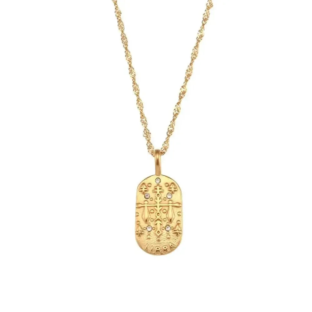 Gold necklace with an oval pendant on a white background