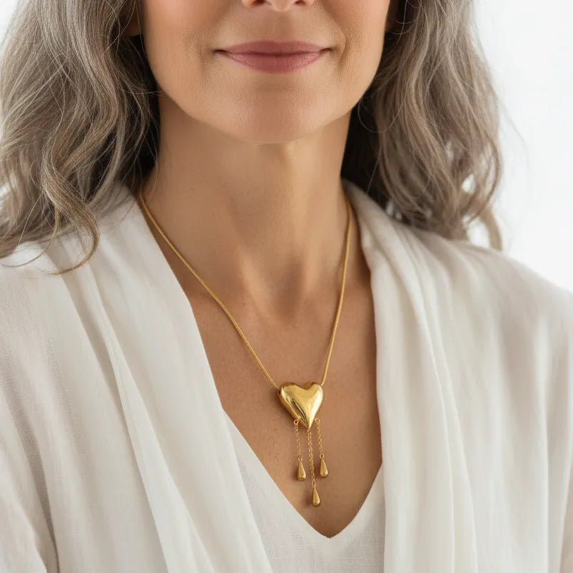 Woman wearing a gold bleeding heart pendant necklace