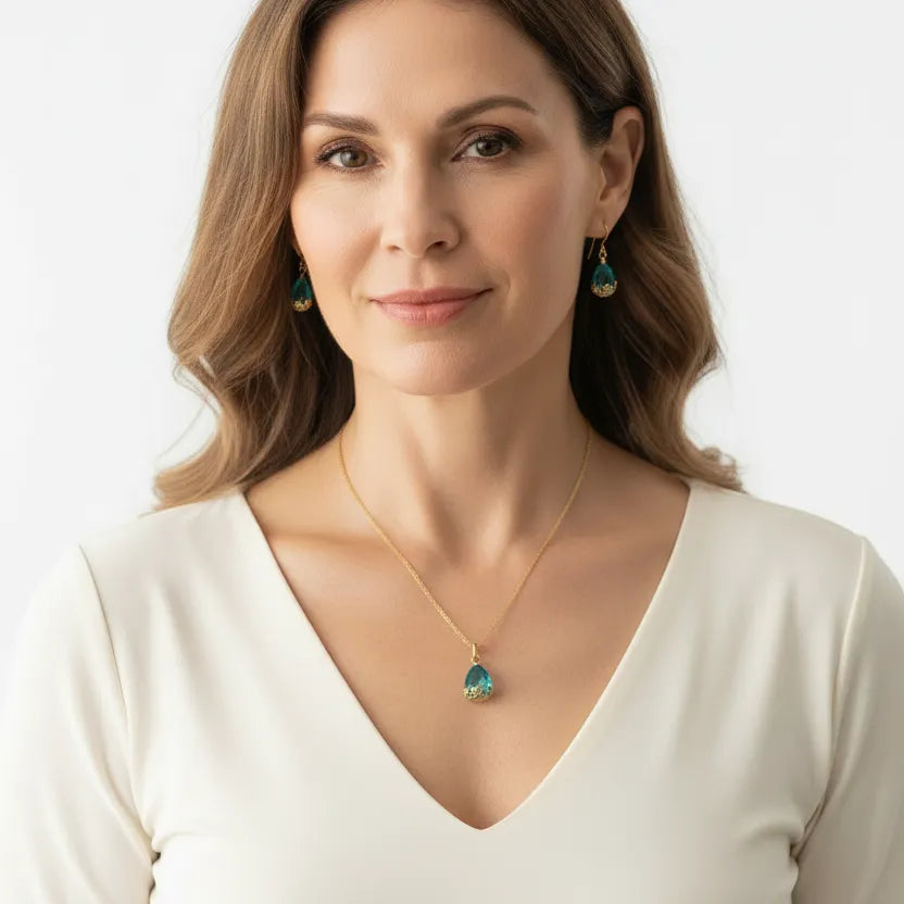 Woman wearing a teal flower cap glass drop necklace