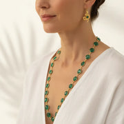 Woman wearing green hydro quartz necklace with snake earrings in gold, serpent symbol jewelry