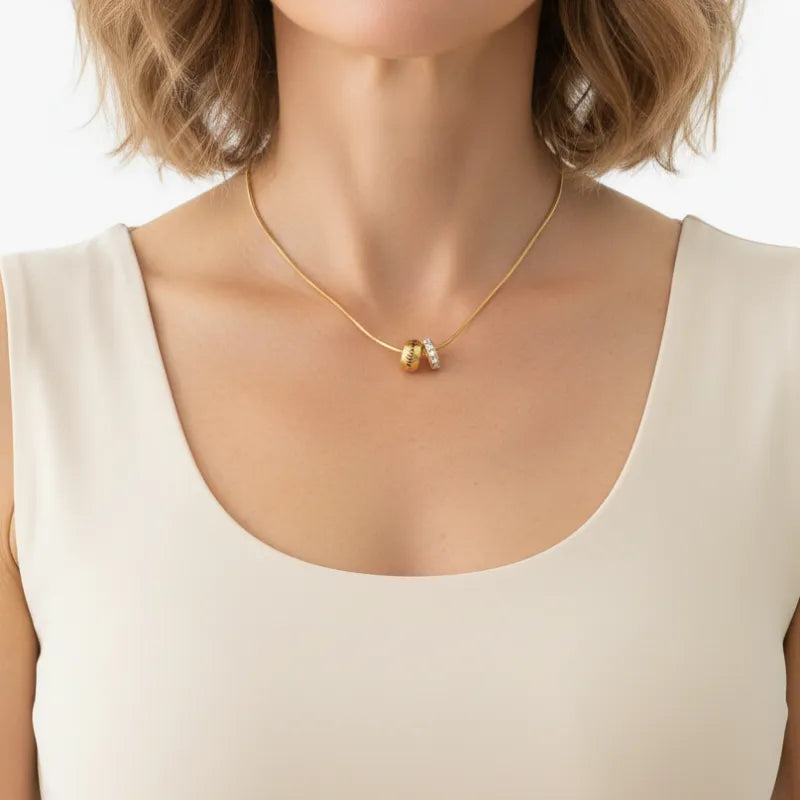 Woman wearing the Heureuse gold pendant necklace