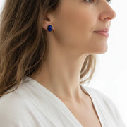 Woman wearing lapis lazuli water drop stud earrings, third eye chakra jewelry