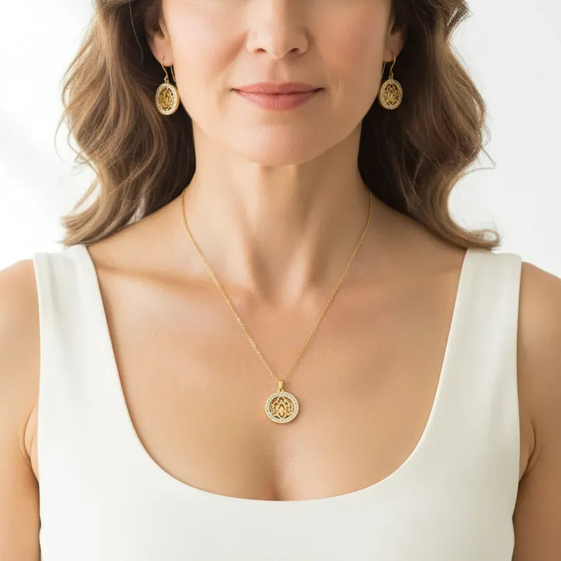 Woman wearing a lotus medallion necklace with matching earrings, spiritual symbol jewelry