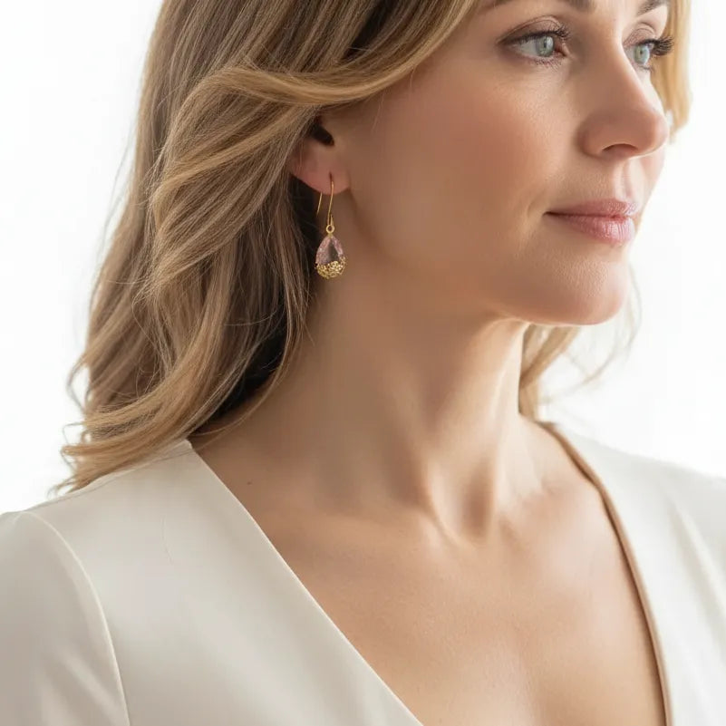 Woman wearing pink flower drop earrings
