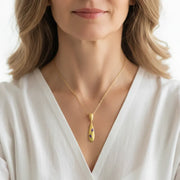 Woman wearing an amethyst tulip pendant necklace, February birthstone jewelry