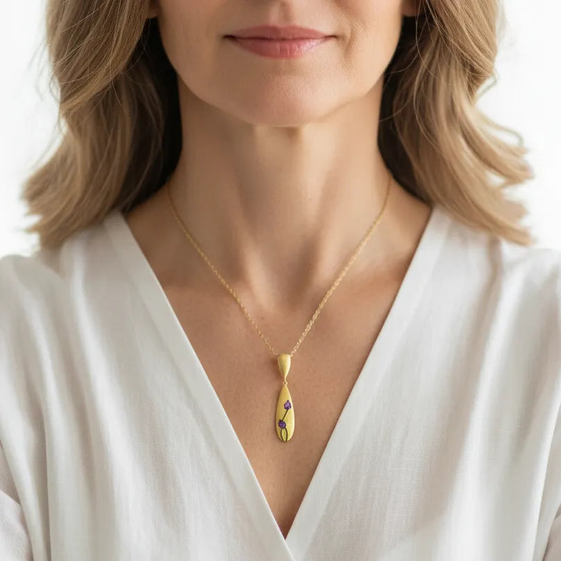Woman wearing an amethyst tulip pendant necklace, February birthstone jewelry