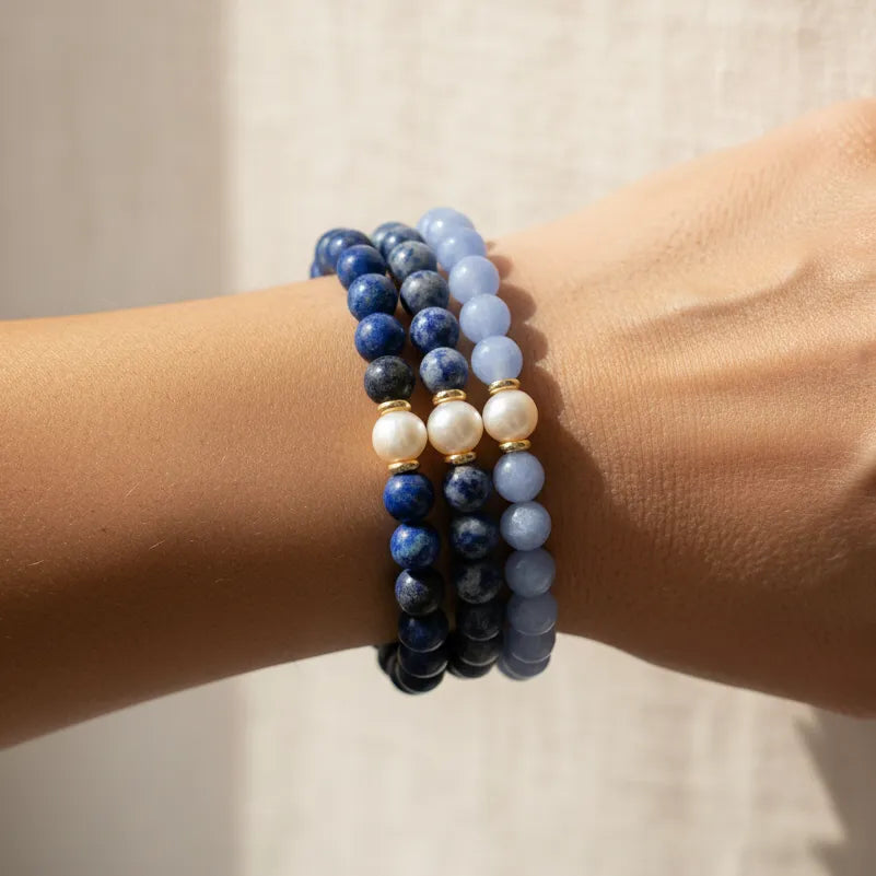 Woman wearing a sodalite and blue lace agate pearl bracelet stack