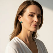 Woman wearing amazonite stud earrings — throat chakra jewelry for calm and communication