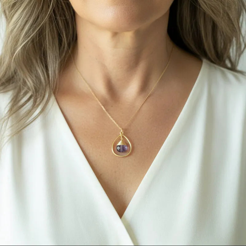 Woman wearing the thin genuine amethyst drop necklace in gold