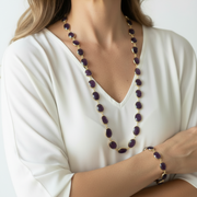 Woman wearing natural amethyst oval necklace and matching bracelet set on gold plated links, February birthstone