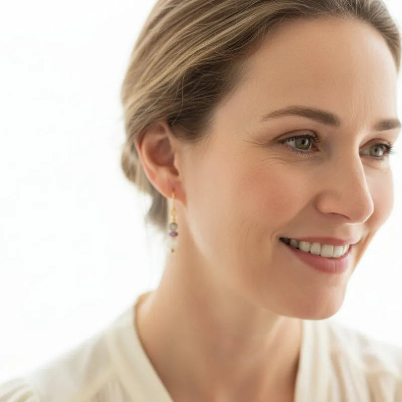 Woman wearing amethyst, freshwater pearl and labradorite drop earrings