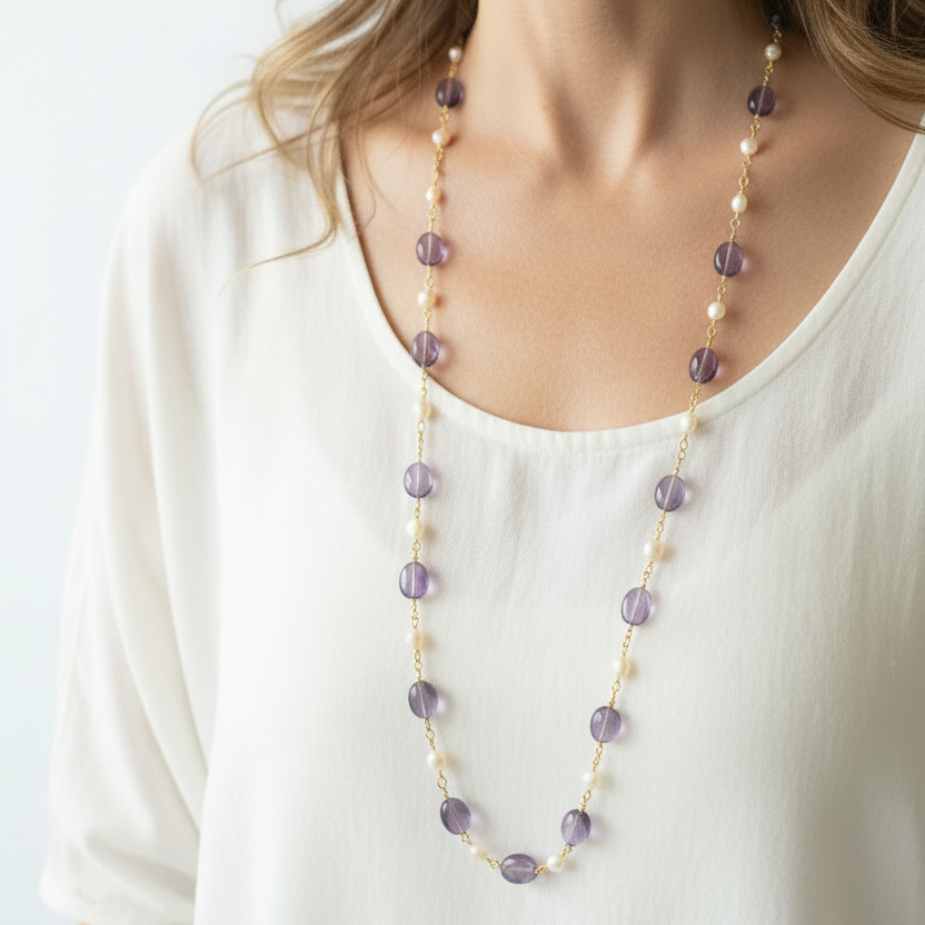 Woman wearing hand-wrapped amethyst and freshwater pearl long layering necklace, February and June birthstone