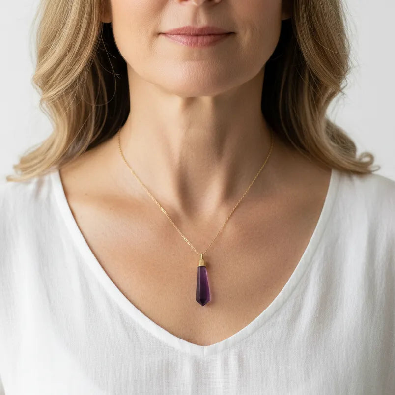Woman wearing an amethyst pendulum necklace, February birthstone jewelry