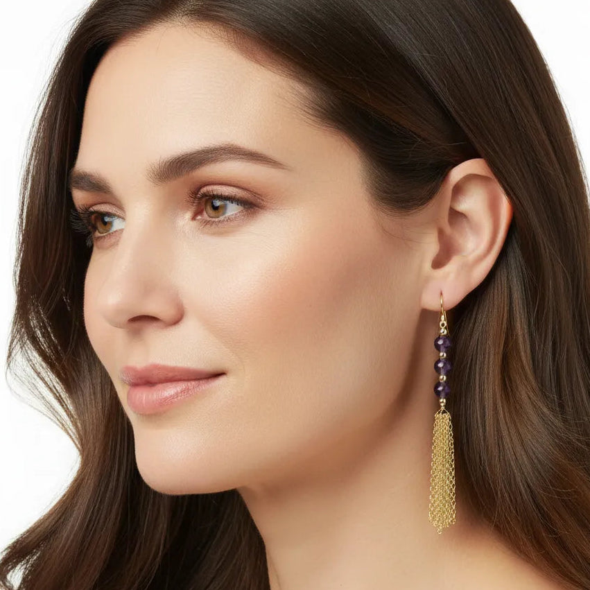woman wearing gold amethyst chain dangle earrings — February birthstone jewelry