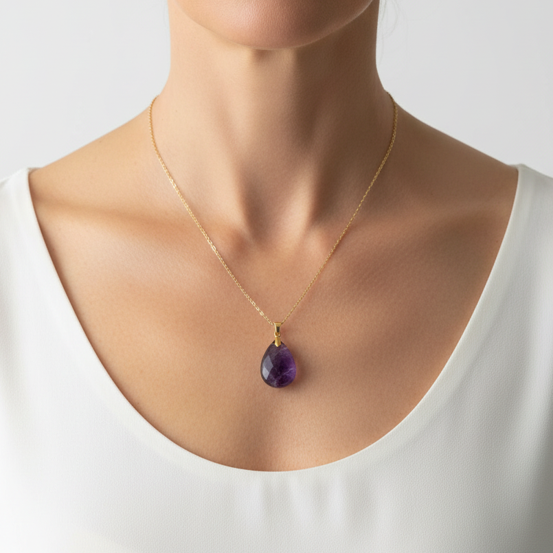 Woman wearing a gold amethyst teardrop pendant necklace — February birthstone jewelry