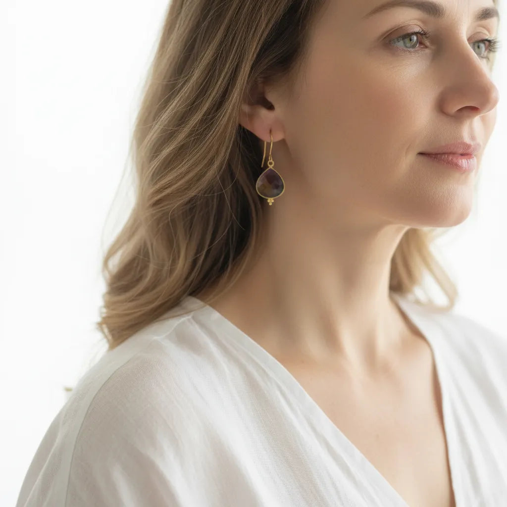 Woman wearing gold ametrine drop earrings