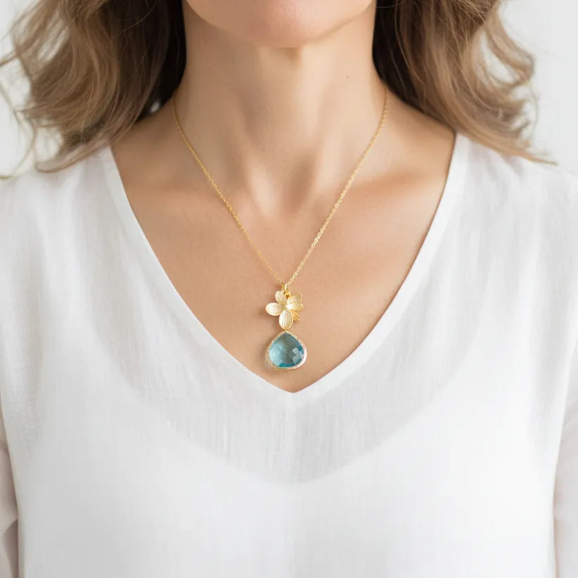 Orchid glass drop necklace in aqua blue, worn at the collarbone