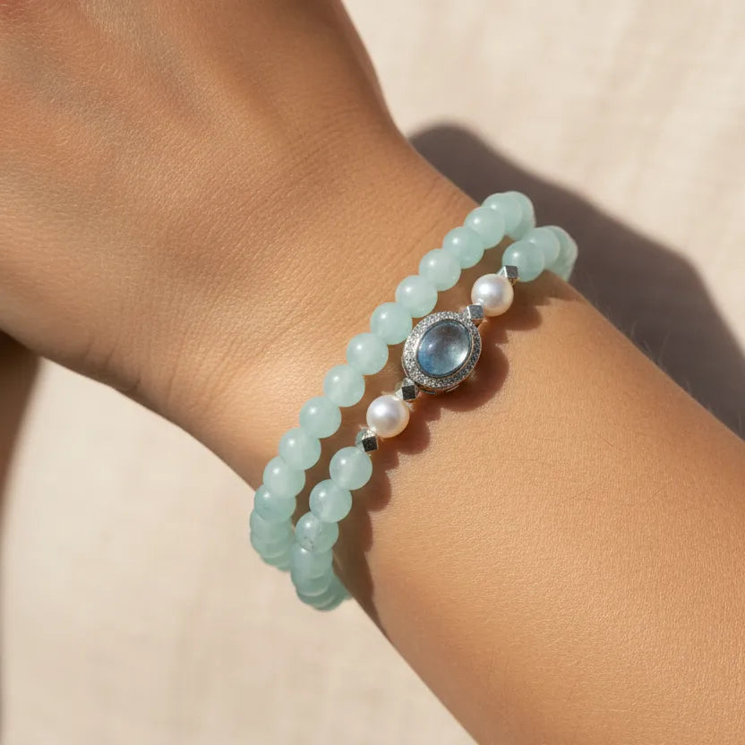 Woman wearing an aquamarine stretch bracelet set, March birthstone jewelry